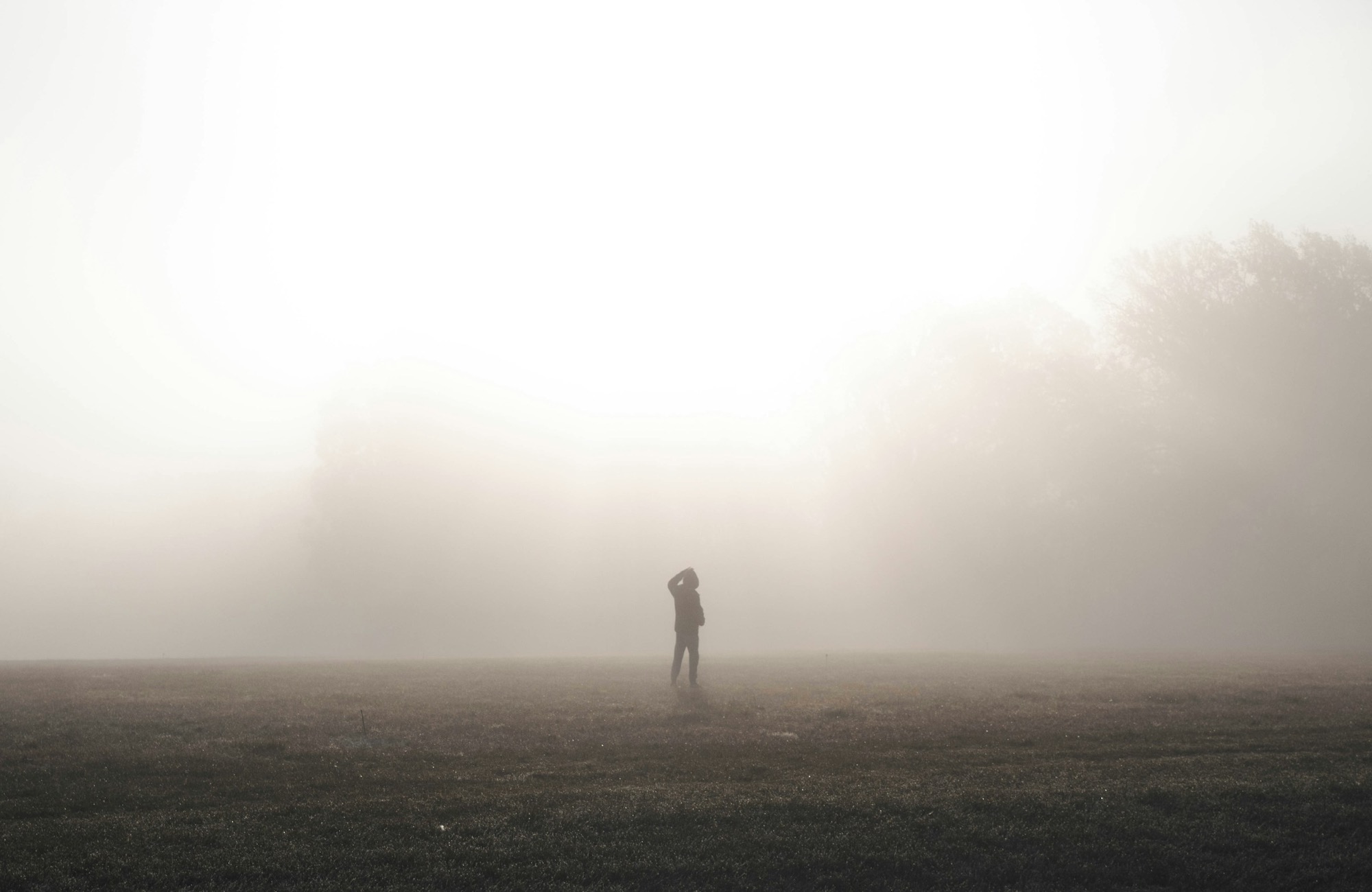 A lone figure in warm morning fog